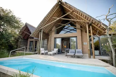 a house with a swimming pool in front of it at Kapama Southern Camp in Kapama Private Game Reserve