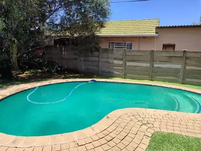 a small pool in a yard with a fence at Mvuli haven in Pretoria