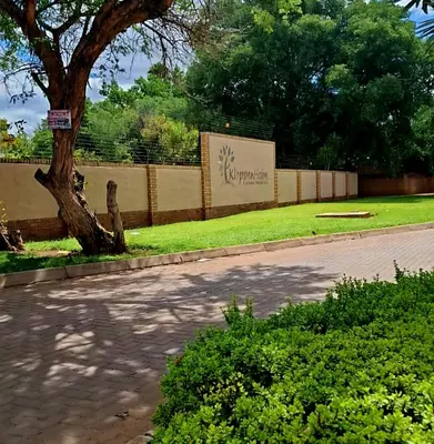 a park with a fence and a tree and grass at Kloppenheim Sectional Lifestyle Complex in Ellisras