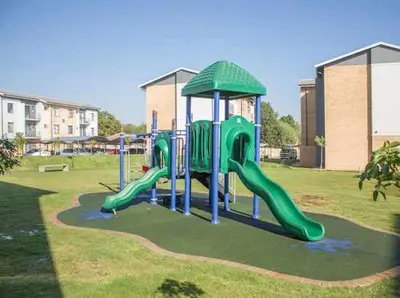a playground with a slide in a park at True Star at True North Modern 2 Bed Apartment in Pretoria
