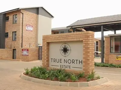 a sign for a true north site in front of a building at True Star at True North Modern 2 Bed Apartment in Pretoria