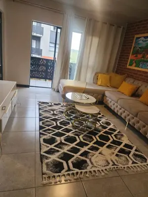 a living room with a couch and a table at The white house in Midrand