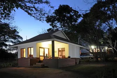 a small house is lit up at night at Heuglins Lodge in White River