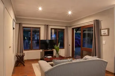 a living room with a couch and a tv at Heuglins Lodge in White River