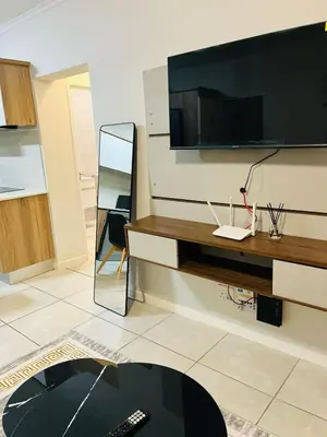 a living room with a television on a wall at The Luxurious Retreat in Kyalami in Midrand