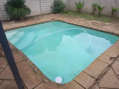 a small pool with blue water in a backyard at 329 on 30th Avenue Villieria Aimee in Pretoria