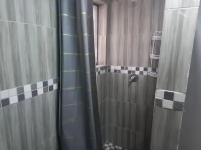 a bathroom with a shower with a shower curtain at 329 on 30th Avenue Villieria Aimee in Pretoria