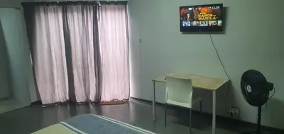 a room with a table and a fan and a television at 329 on 30th Avenue Villieria Aimee in Pretoria