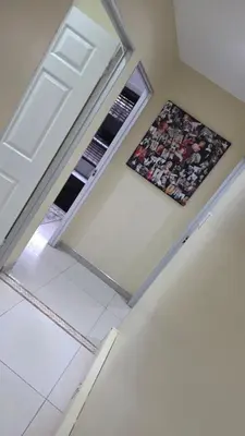 an empty room with a refrigerator and a window at ntaleguesthouse in Benoni