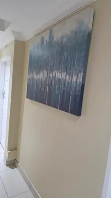 a painting hanging on a wall in a room at ntaleguesthouse in Benoni