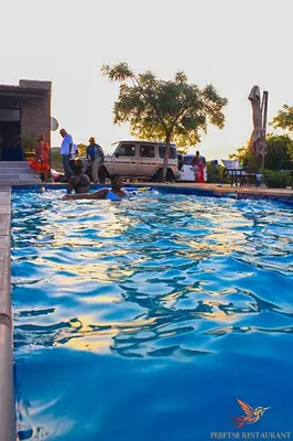 a group of people in a swimming pool at Pebetse Guesthouse in Acornhoek
