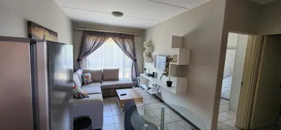 a living room with a couch and a window at Peaceful Casa in Kempton Park