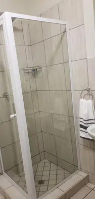 a shower with a glass door in a bathroom at Peaceful Casa in Kempton Park