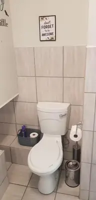 a bathroom with a toilet and a sign on the wall at Peaceful Casa in Kempton Park