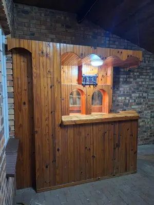 a wooden building with a bar in the middle at Stay-on-Skalie in Nelspruit