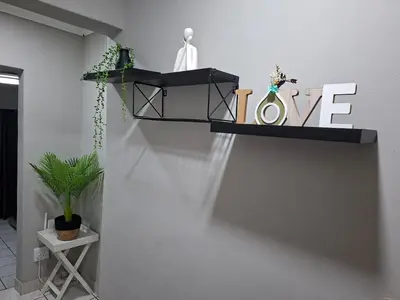 a shelf with the word love on a wall at Stay-on-Skalie in Nelspruit