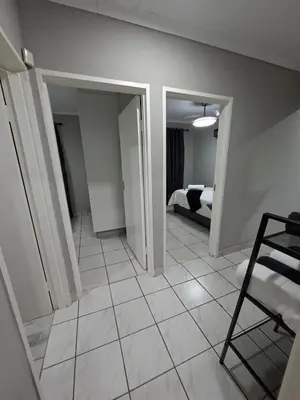 a room with a room with a bed and a tiled floor at Stay-on-Skalie in Nelspruit