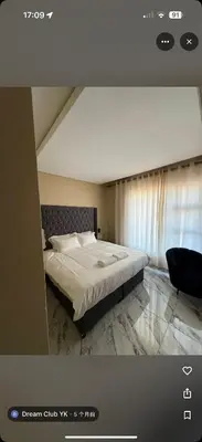 a bedroom with a large bed and a window at dream club in Thohoyandou