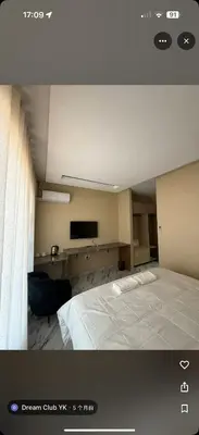 a bedroom with a white bed and a television at dream club in Thohoyandou