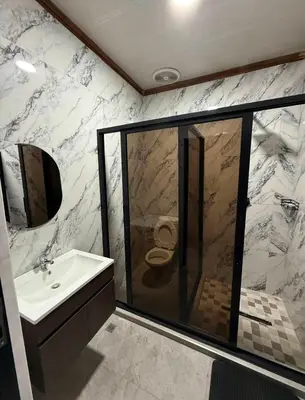 a bathroom with a shower with a toilet and a sink at dream club in Thohoyandou