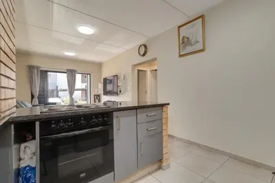 a kitchen with a sink and a dishwasher at Home Away By Waterfall in Midrand