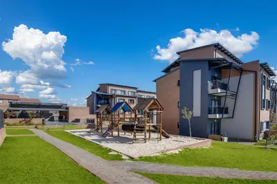 a playground in a park in front of a building at Home Away By Waterfall in Midrand