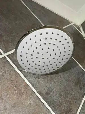 a metal strainer sitting on a tiled floor at Oasis Nest in Pretoria