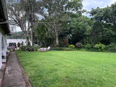 a park with a bench in the middle of a yard at Nut Tree Nook in Hazyview