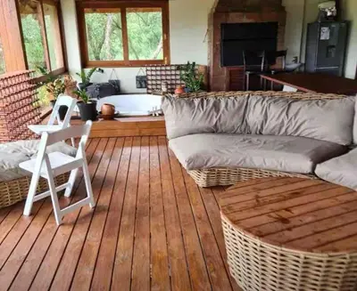 a living room with a couch and a chair on a wooden floor at RSM Country Estate Unit 2 in Nelspruit