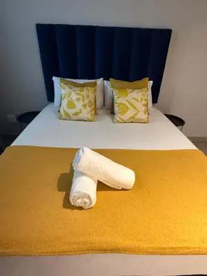 a roll of toilet paper sitting on a bed at CIRCA Lynwood Air B&B in Pretoria