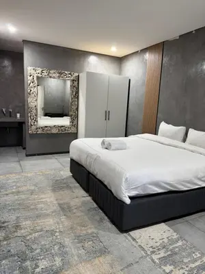 a bedroom with a large bed and a mirror at Bras boutique in Steelpoort
