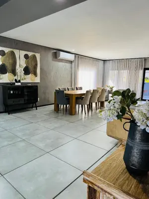 a dining room with a table and chairs at Bras boutique in Steelpoort