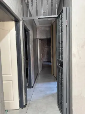 a hallway in a building with a door open at Bras boutique in Steelpoort