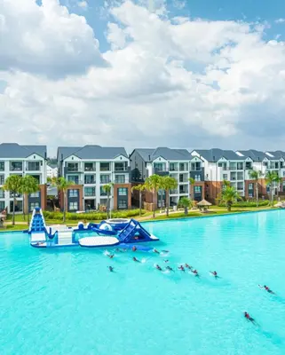 a boat in the water in front of condos at The Blyde Crystal Lagoon Pretoria in Pretoria