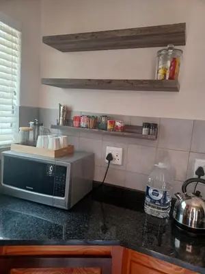 a kitchen counter with a microwave on a counter top at The Roaches in White River