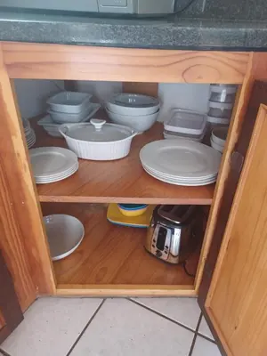 a cabinet filled with white plates and bowls at The Roaches in White River