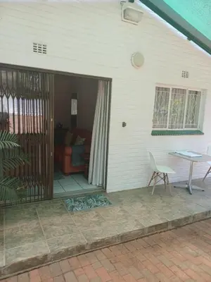 a screened in porch with a table and a chair at The Roaches in White River