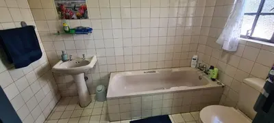a bathroom with a tub and a sink and a toilet at Jireh in Pretoria