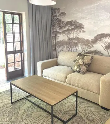 a living room with a couch and a coffee table at Critchley Hackle - Deluxe garden units in Dullstroom