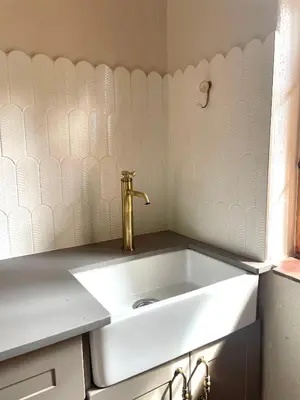 a white sink with a gold faucet in a bathroom at Critchley Hackle - Deluxe garden units in Dullstroom