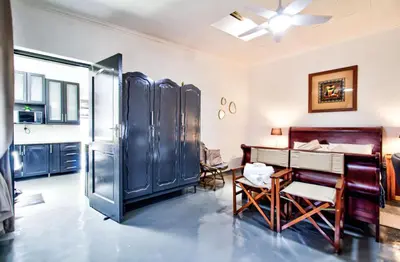 a kitchen with a refrigerator and a table and chairs at Peaceful luxurious fully-equipped home in Centurion