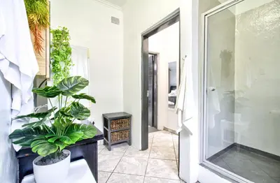 a hallway with a glass door and a plant at Peaceful luxurious fully-equipped home in Centurion