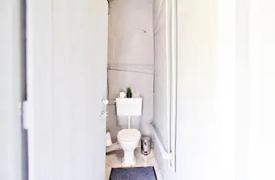 a bathroom with a white toilet in a room at Peaceful luxurious fully-equipped home in Centurion