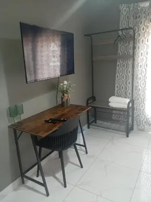 a table and a chair in a room at Comfort place 6 in Pretoria