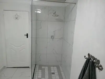 a shower with a glass door in a bathroom at Comfort place 6 in Pretoria
