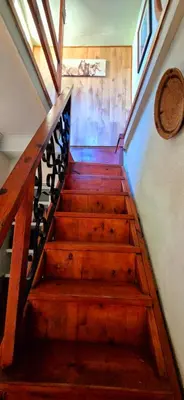 a wooden staircase in a house with wooden stairs at Mountain Haven Kaapsehoop in Kaapsehoop