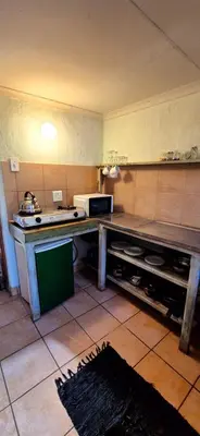 a kitchen with a table and a microwave in it at Mountain Haven Kaapsehoop in Kaapsehoop