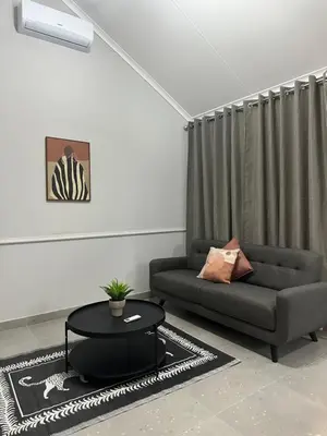 a living room with a couch and a table at Pendleberry Grove 33 in Bela-Bela