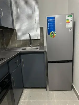 a white refrigerator in a kitchen with a sink at Pendleberry Grove 90 in Bela-Bela