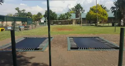 two picnic tables in a park with a net at Pendleberry Grove 90 in Bela-Bela